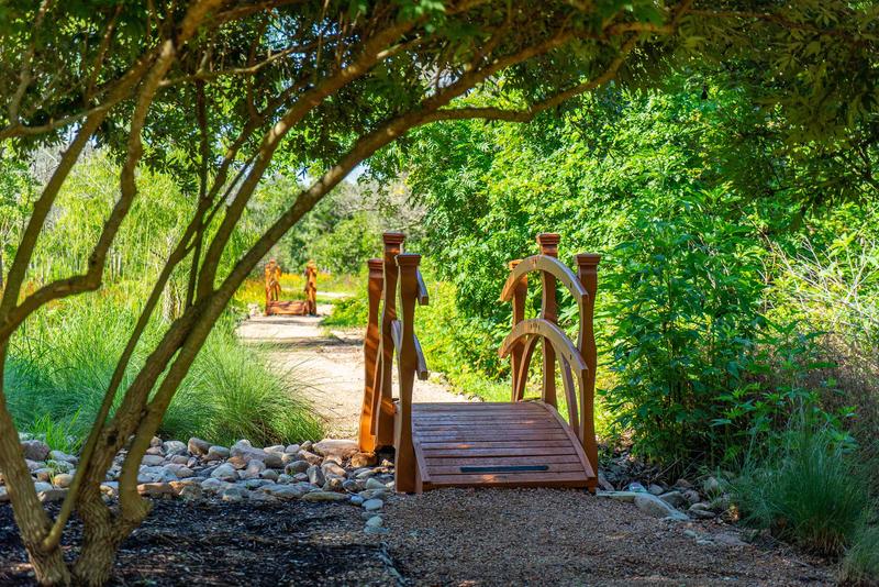 A quiet pathway leads you over wooden bridges for a quiet, contemplative space during your wellness retreat.